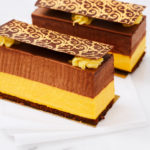 Sponge cake with chocolate and mango mousse. Horizontal shot